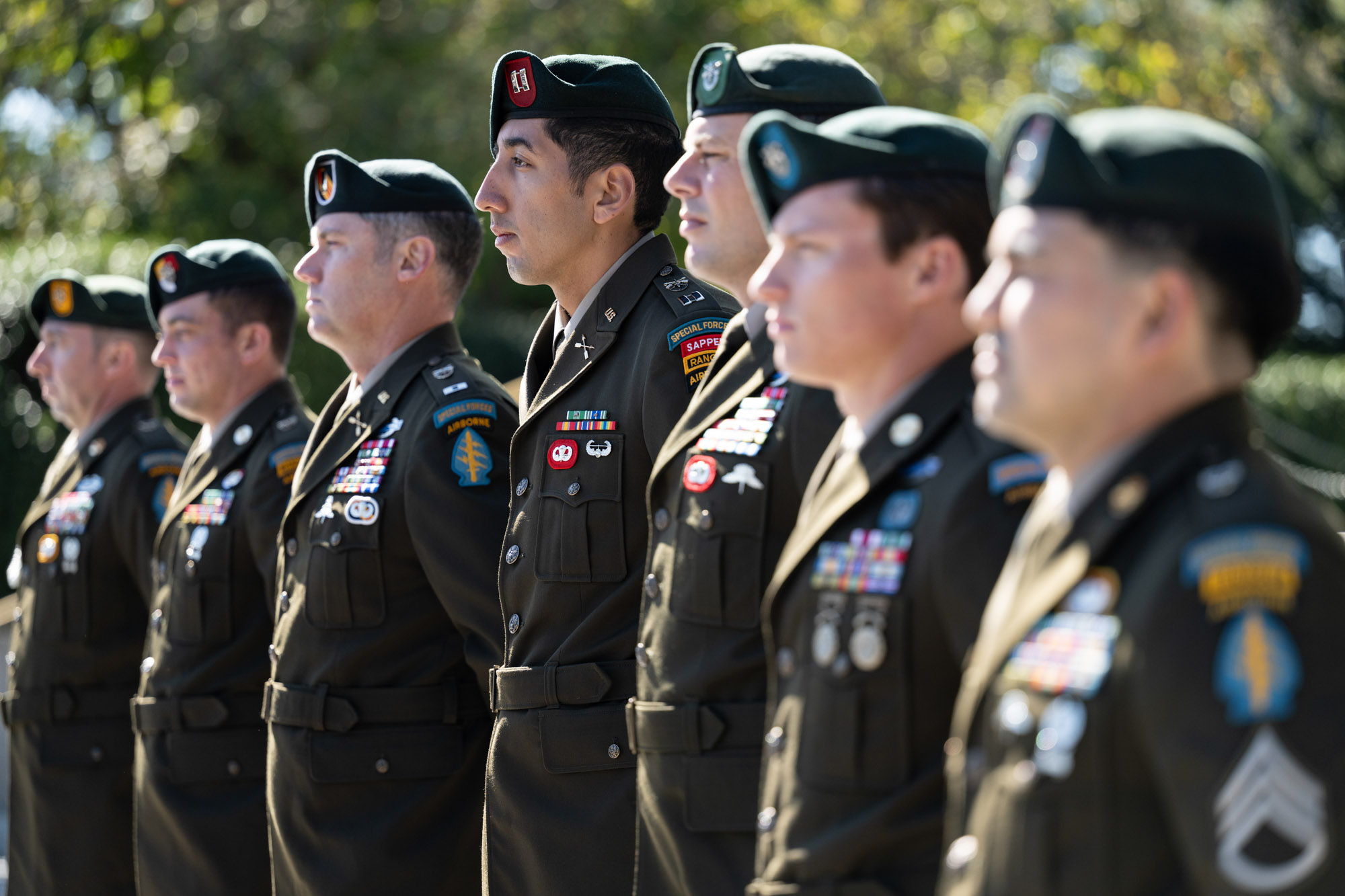 Soldiers in uniform standing in line outdoors