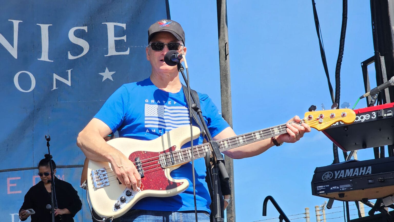 Man playing bass guitar on outdoor stage