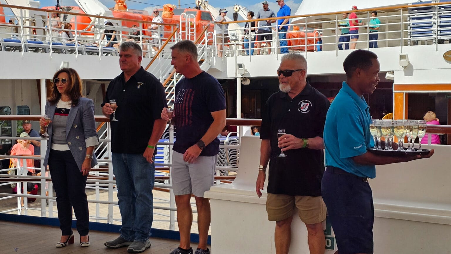 Guests enjoying champagne on cruise ship deck