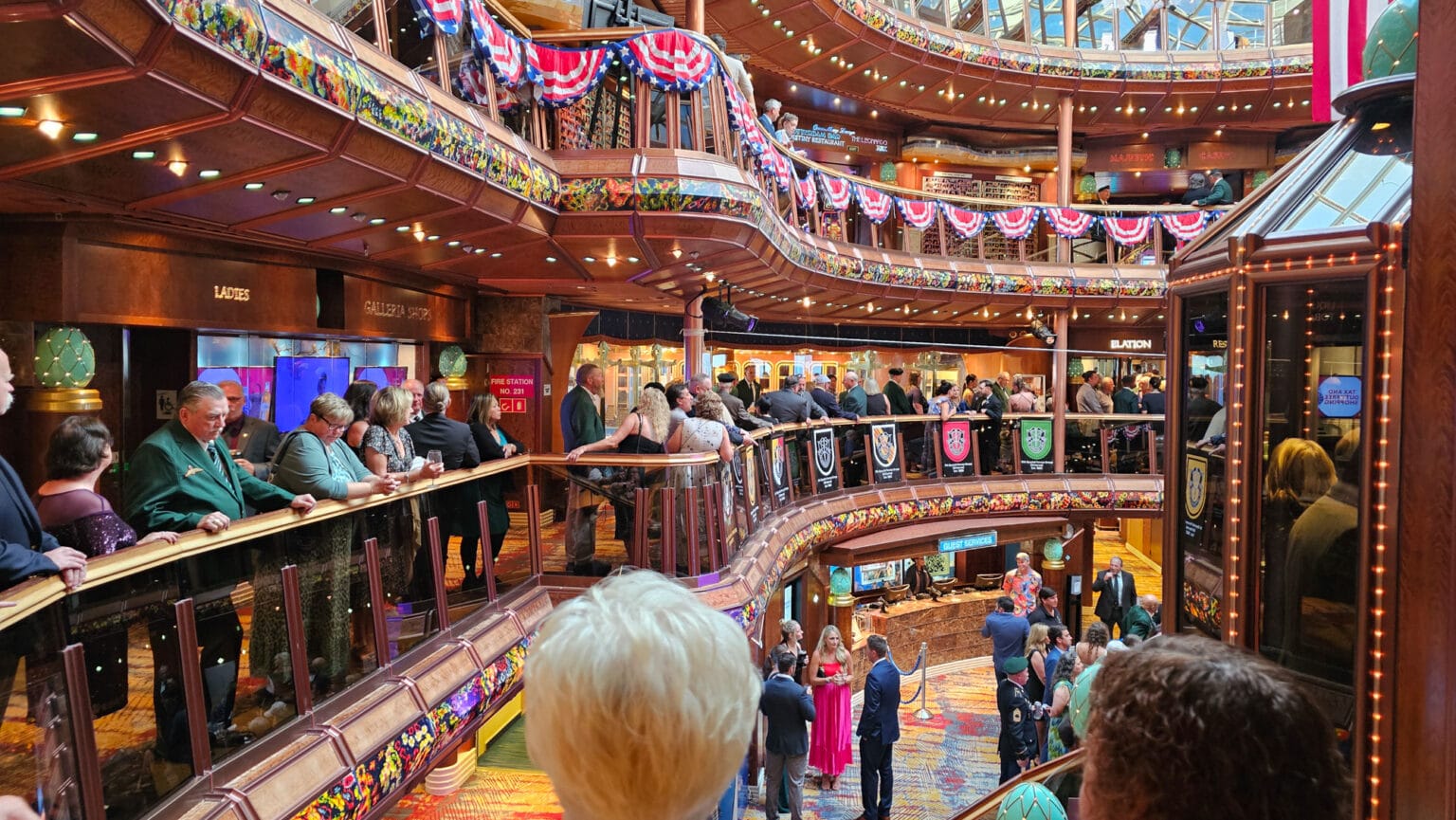Crowded cruise ship atrium during formal event
