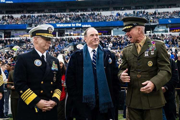 Military officers and official at a football game.