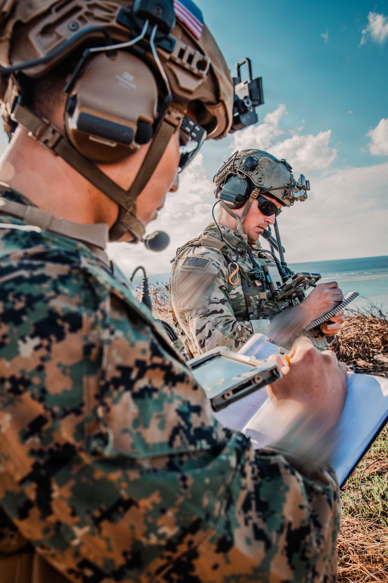 Soldiers using communication equipment outdoors