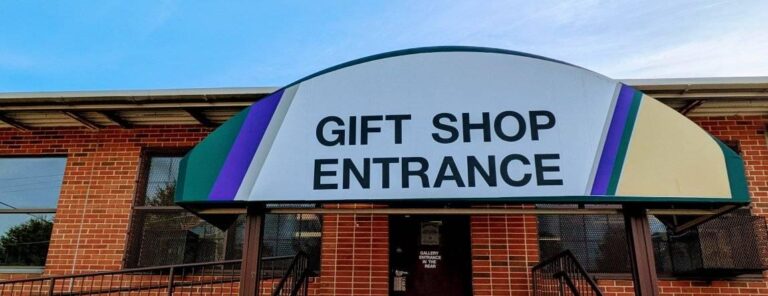 Gift shop entrance sign on brick building