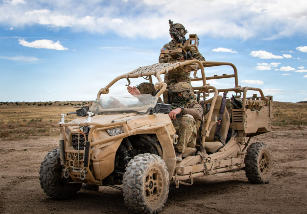 Soldiers on armed off-road vehicle in desert