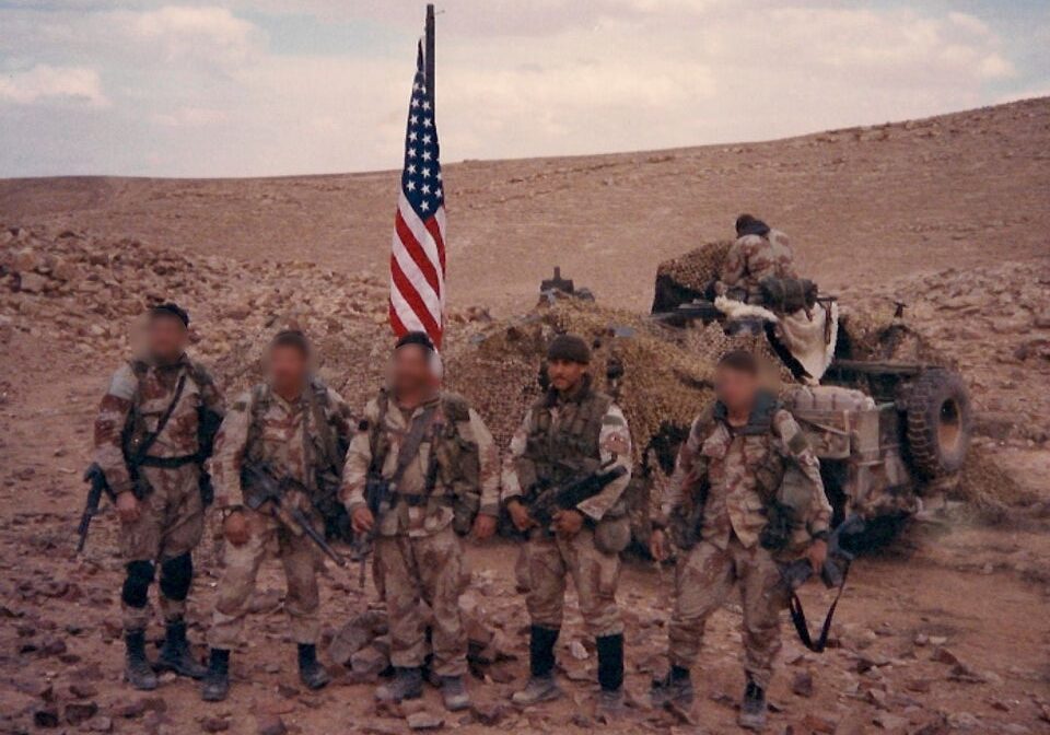U.S. soldiers in desert with American flag