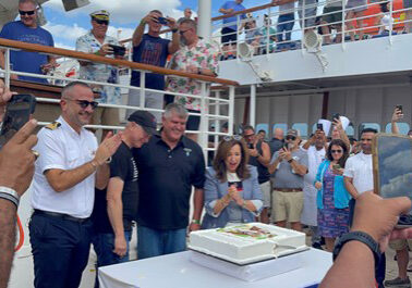 People celebrating with a cake on a cruise ship.