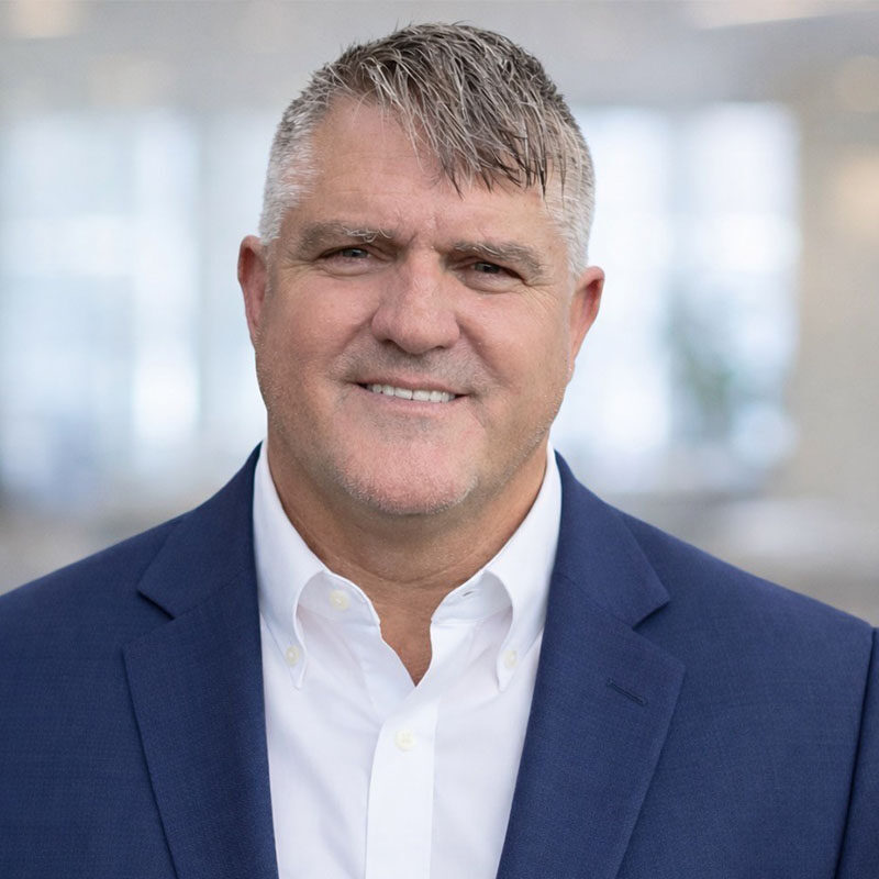 Smiling man in blue blazer portrait headshot