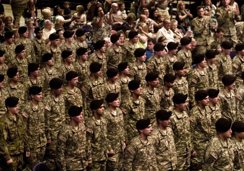 Rows of soldiers in camouflage at ceremony