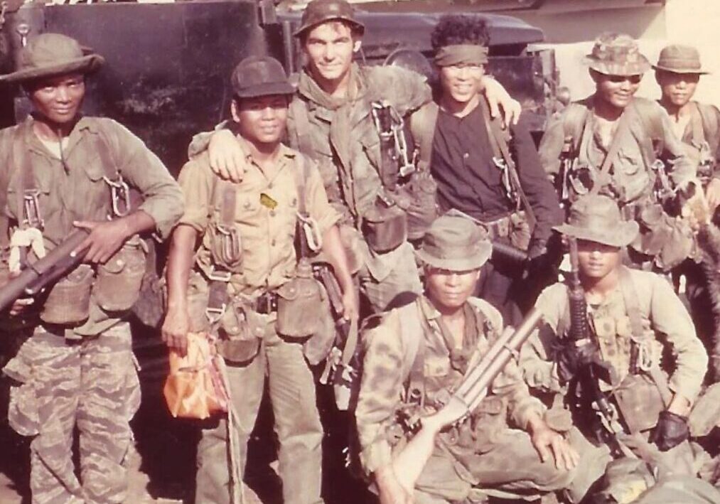 Group of soldiers posing with rifles and gear